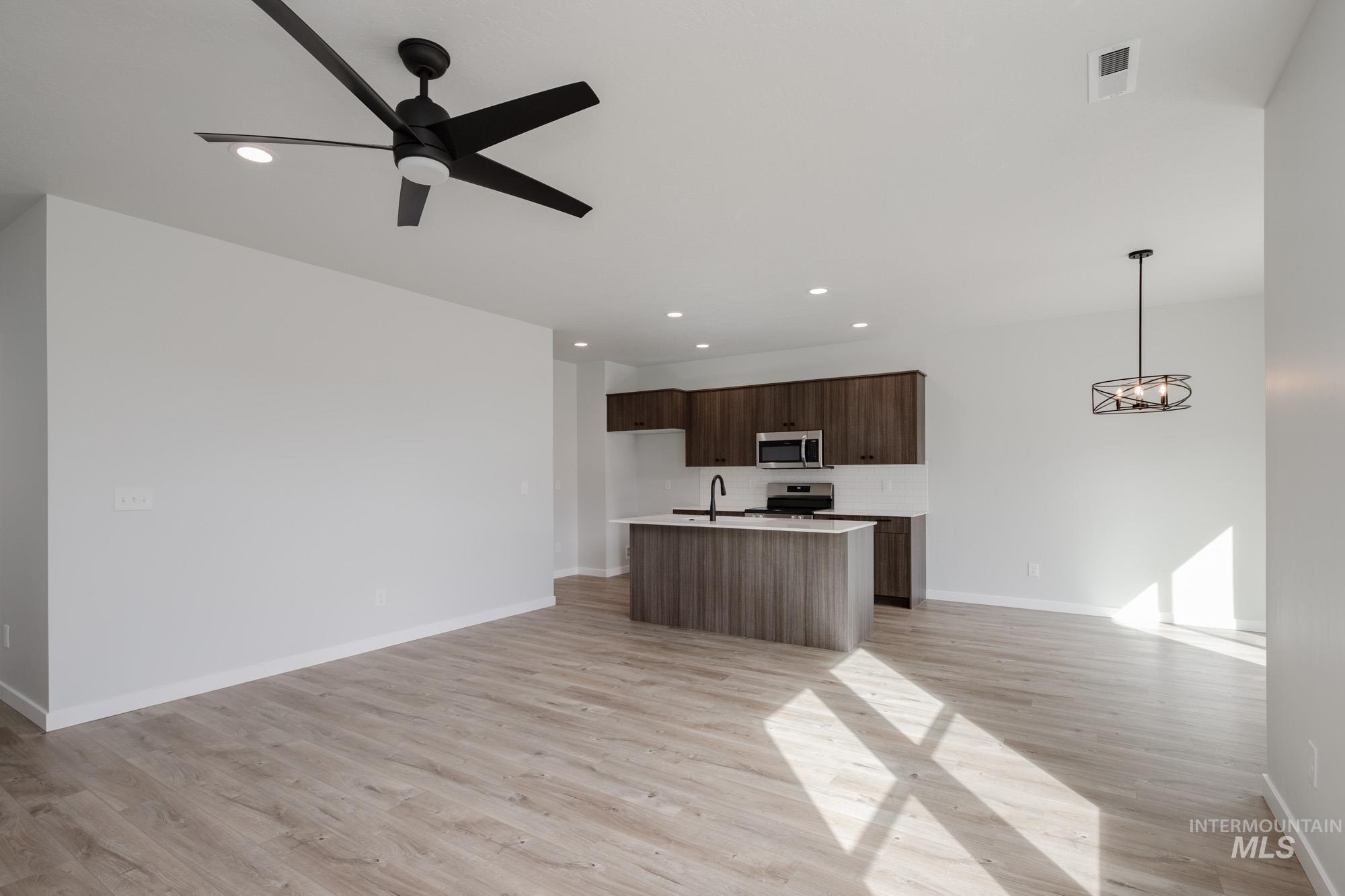 2192 South Border Way Meridian, ID 83642 - Photo 22 of 22 Kitchen with open floor plan, light countertops, light wood-type flooring, a center island with sink, and modern cabinets