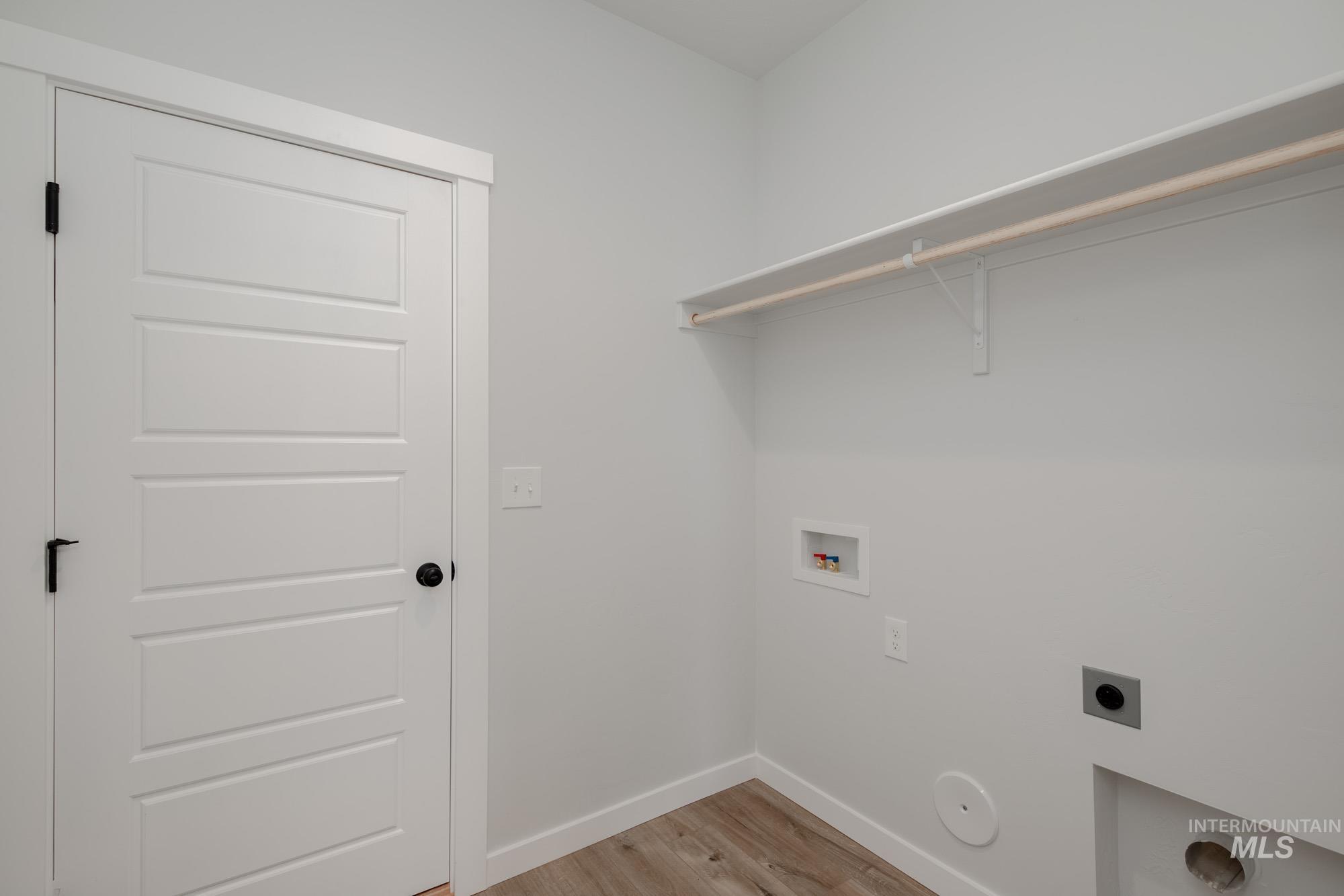 2192 South Border Way Meridian, ID 83642 - Photo 10 of 22 Laundry area with light wood-style floors, electric dryer hookup, and washer hookup