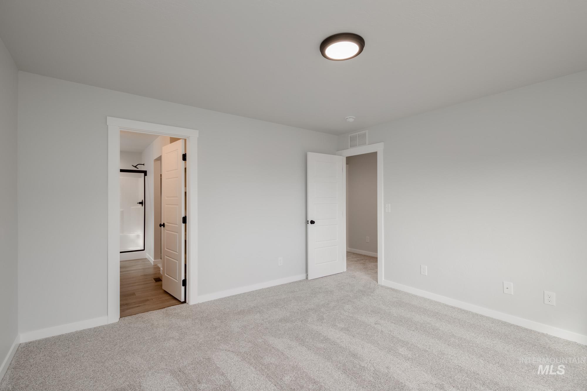 2192 South Border Way Meridian, ID 83642 - Photo 15 of 22 Unfurnished bedroom with light carpet and ensuite bath