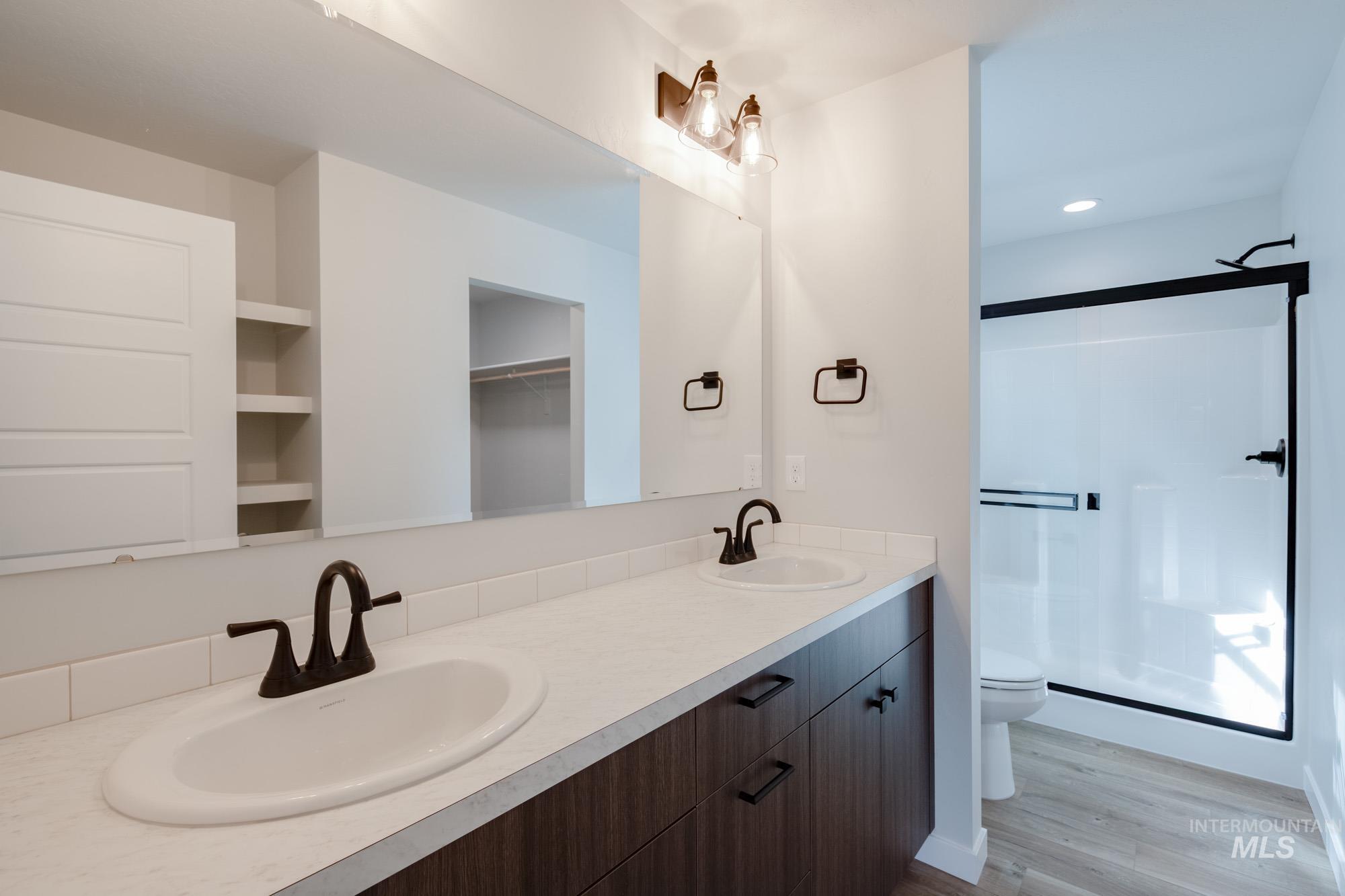 2192 South Border Way Meridian, ID 83642 - Photo 16 of 22 Bathroom with a shower stall, double vanity, light wood-type flooring, and recessed lighting
