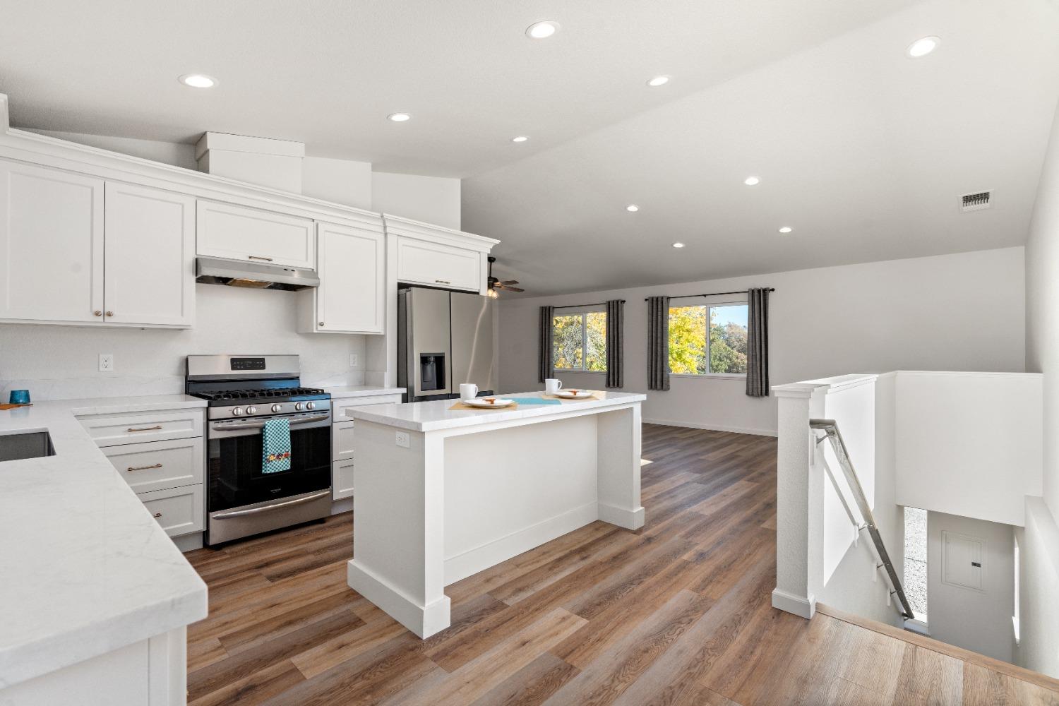 16153 Indian Springs Road Penn Valley, CA 95946 - Photo 30 of 64 a kitchen with stainless steel appliances white cabinets a sink a stove a refrigerator and white cabinets