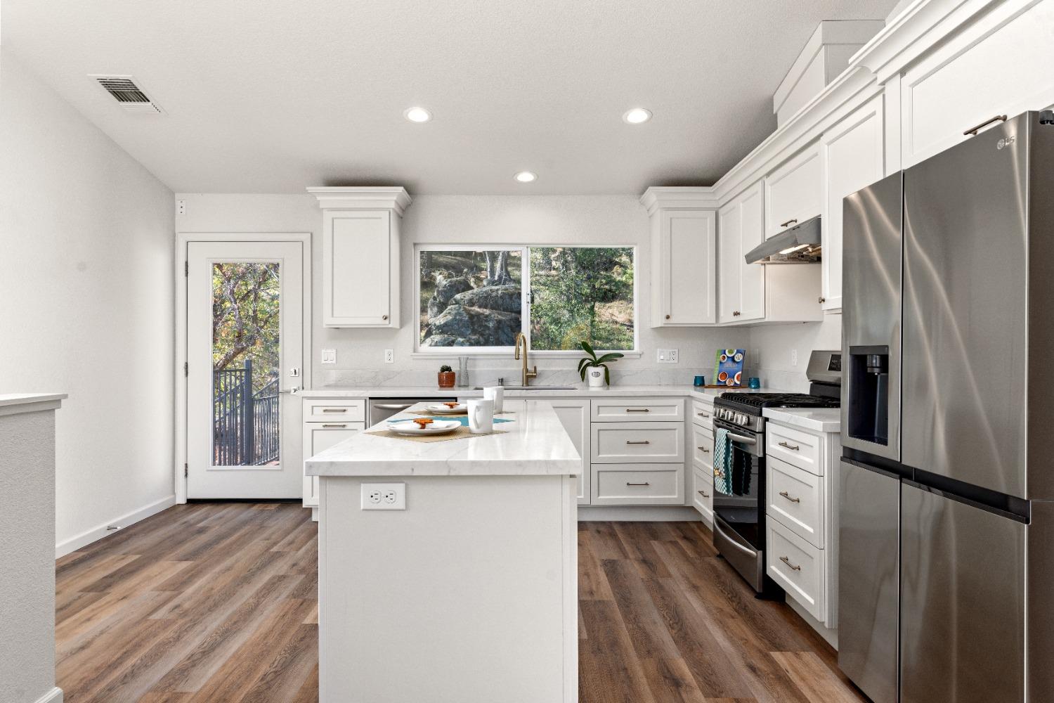 16153 Indian Springs Road Penn Valley, CA 95946 - Photo 33 of 64 a kitchen with a sink stainless steel appliances a window and a counter top space