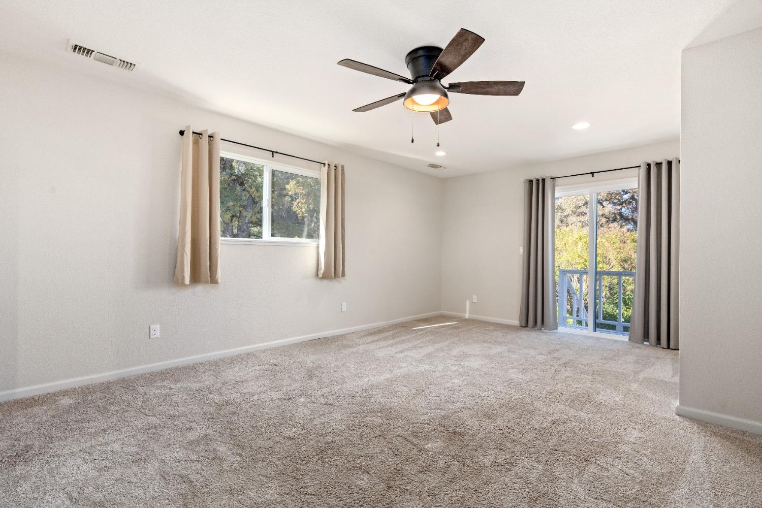 16153 Indian Springs Road Penn Valley, CA 95946 - Photo 41 of 64 an empty room with windows and ceiling fan