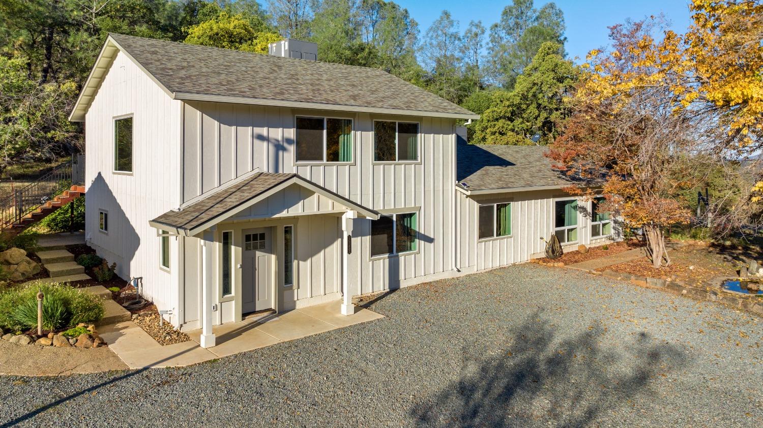 16153 Indian Springs Road Penn Valley, CA 95946 - Photo 6 of 64 a white house that has a tree in front of it