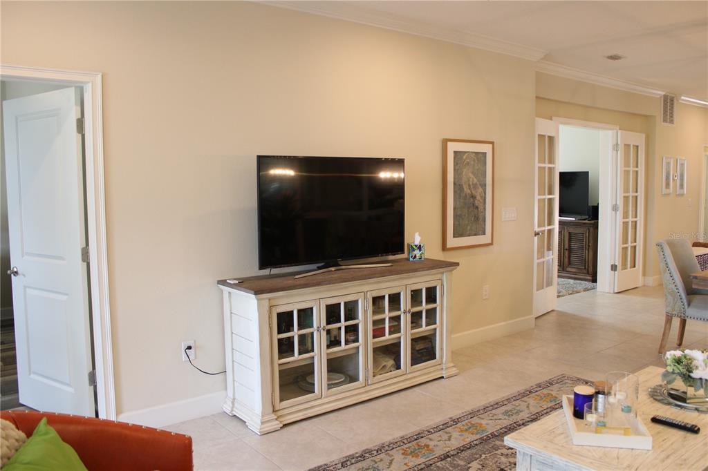 13711 Messina Loop, Unit 104 Bradenton, FL 34211 - Photo 12 of 70 a living room with furniture and a flat screen tv