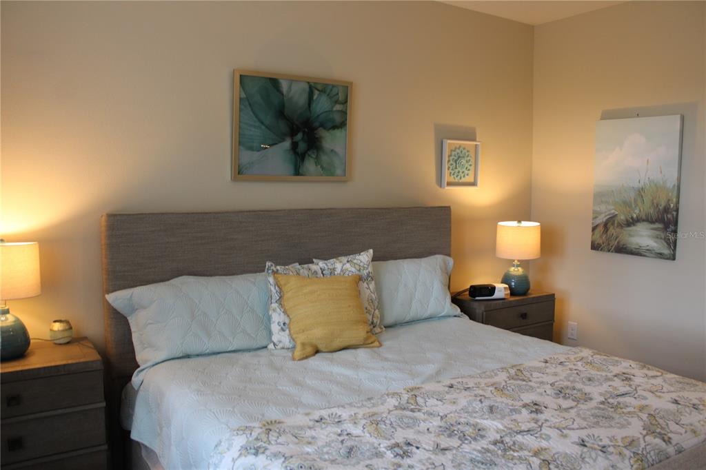 13711 Messina Loop, Unit 104 Bradenton, FL 34211 - Photo 17 of 70 a bedroom with a bed and a painting on the wall