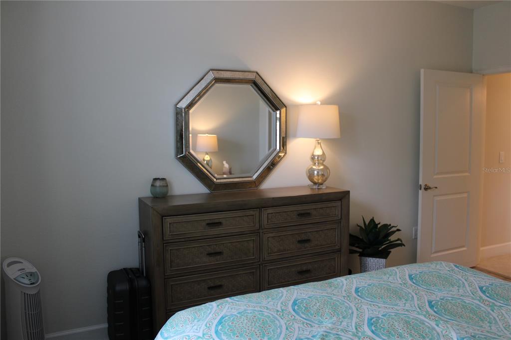 13711 Messina Loop, Unit 104 Bradenton, FL 34211 - Photo 26 of 70 a bed room with a bed and a mirror