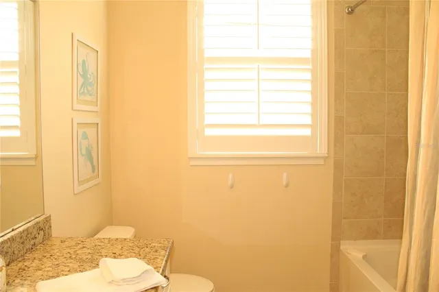 a view of a swimming pool with chairs in patio