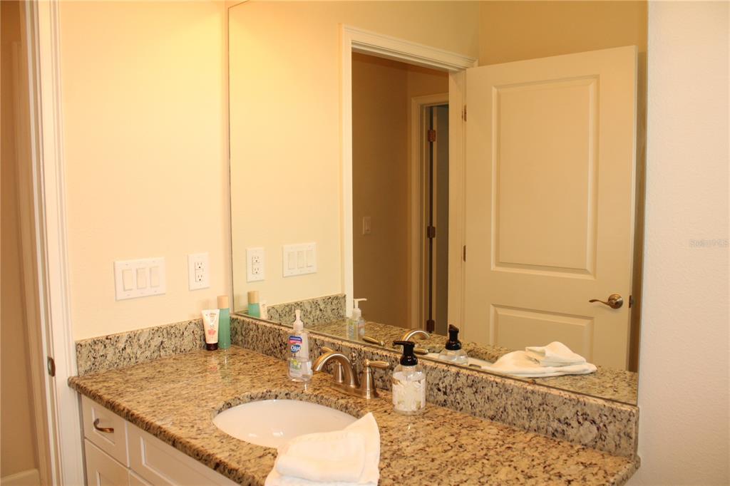 13711 Messina Loop, Unit 104 Bradenton, FL 34211 - Photo 34 of 70 a bathroom with a granite countertop sink and a mirror