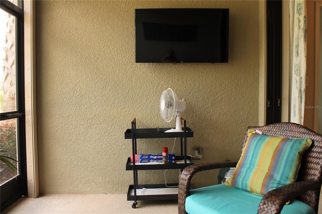 13711 Messina Loop, Unit 104 Bradenton, FL 34211 - Photo 42 of 70 a living room with furniture and a flat screen tv