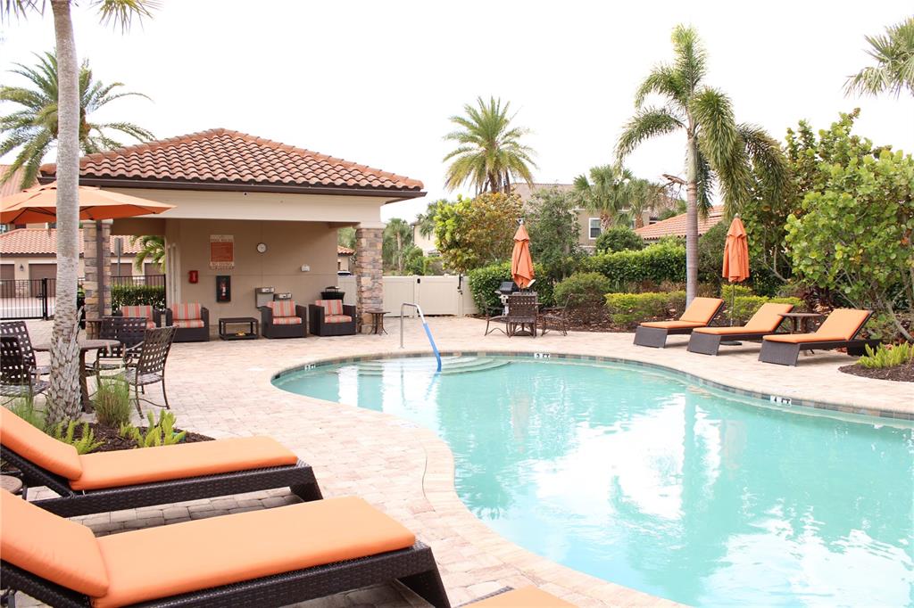 13711 Messina Loop, Unit 104 Bradenton, FL 34211 - Photo 49 of 70 a view of a swimming pool with chairs