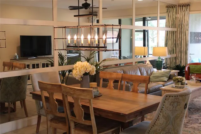 a living room with furniture and view of kitchen
