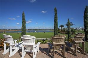 13711 Messina Loop, Unit 104 Bradenton, FL 34211 - Photo 68 of 70 a view of a chairs and table in patio with a lake view