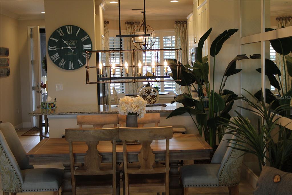 13711 Messina Loop, Unit 104 Bradenton, FL 34211 - Photo 8 of 70 a view of a dining room with furniture and chandelier