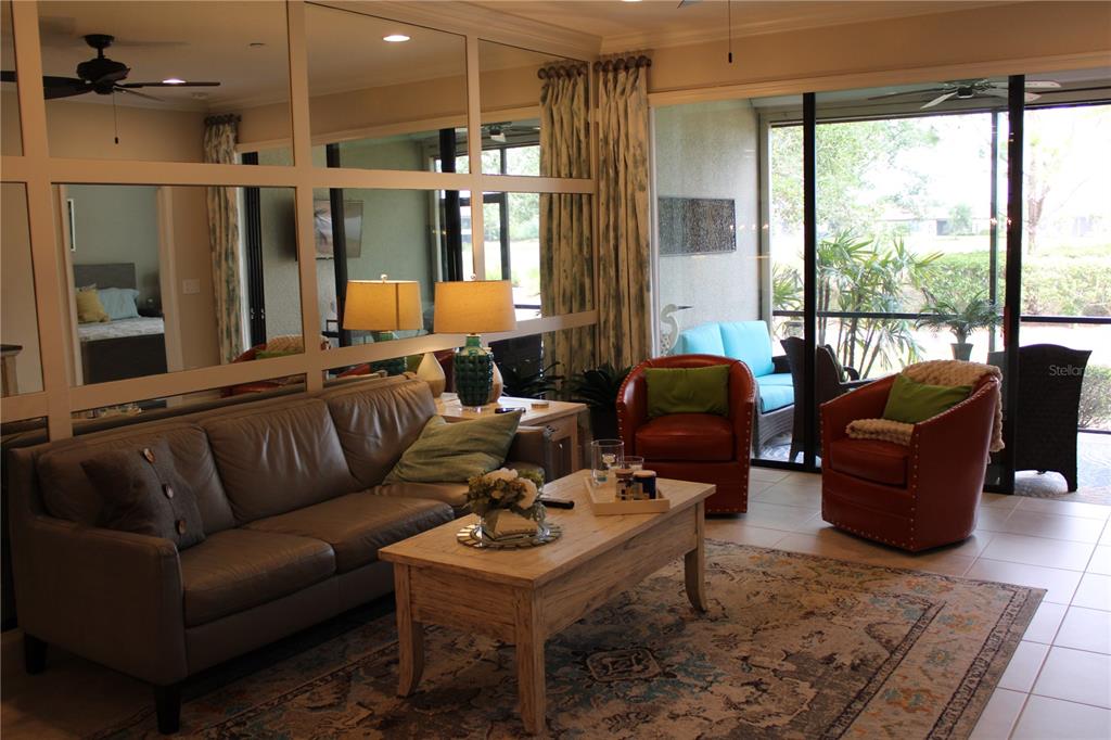 13711 Messina Loop, Unit 104 Bradenton, FL 34211 - Photo 9 of 70 a living room with furniture and a large window