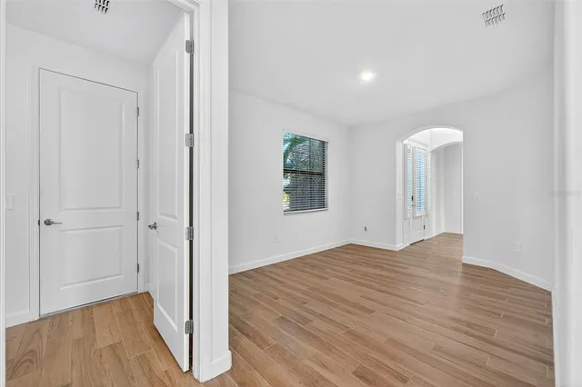 a view of an empty room with wooden floor