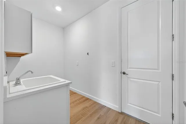 a view of a hallway with wooden floor and entryway