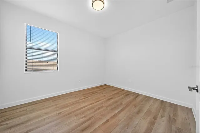 an aerial view of residential houses with outdoor space and ocean view