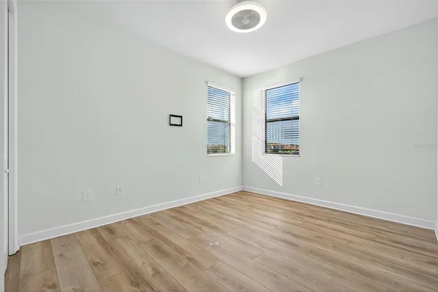 a sign that is sitting on the side of a road with trees