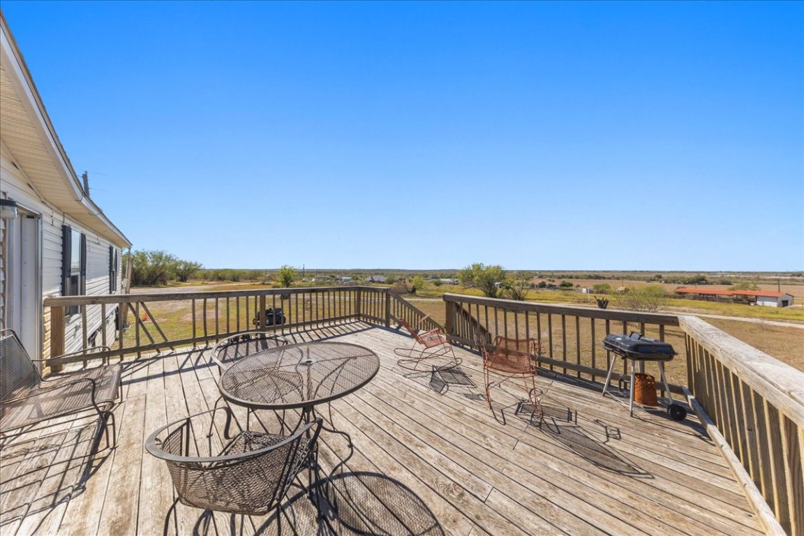 1307 Graef Road, Unit B Kyle, TX 78640 - Photo 13 of 40 a view of a balcony with chair and wooden floor