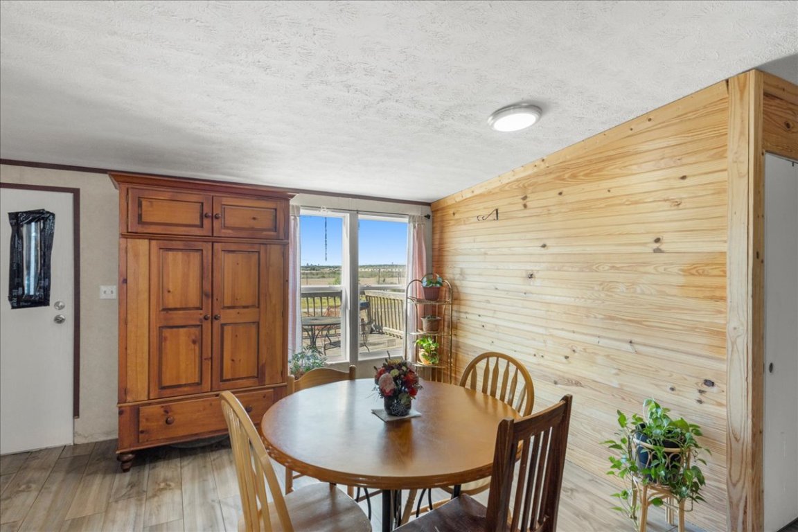 1307 Graef Road, Unit B Kyle, TX 78640 - Photo 17 of 40 a dining room with furniture and wooden floor