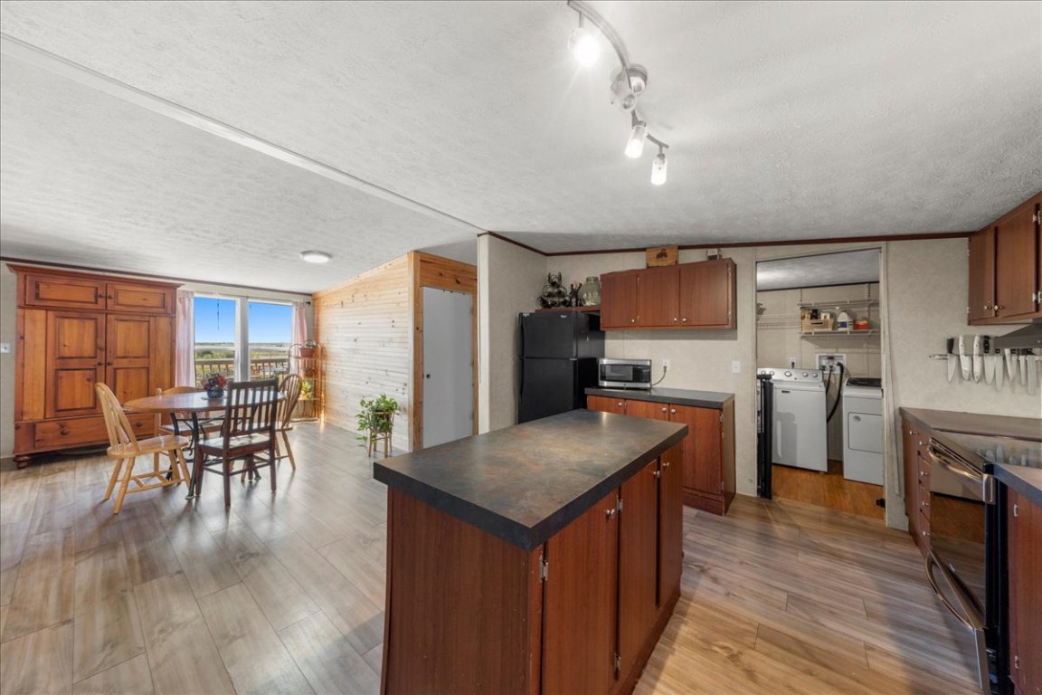 1307 Graef Road, Unit B Kyle, TX 78640 - Photo 21 of 40 a kitchen with stainless steel appliances granite countertop a table chairs sink and stove top oven