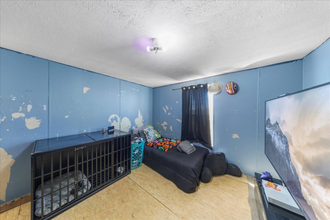 1307 Graef Road, Unit B Kyle, TX 78640 - Photo 29 of 40 a bedroom with bed and a chandelier