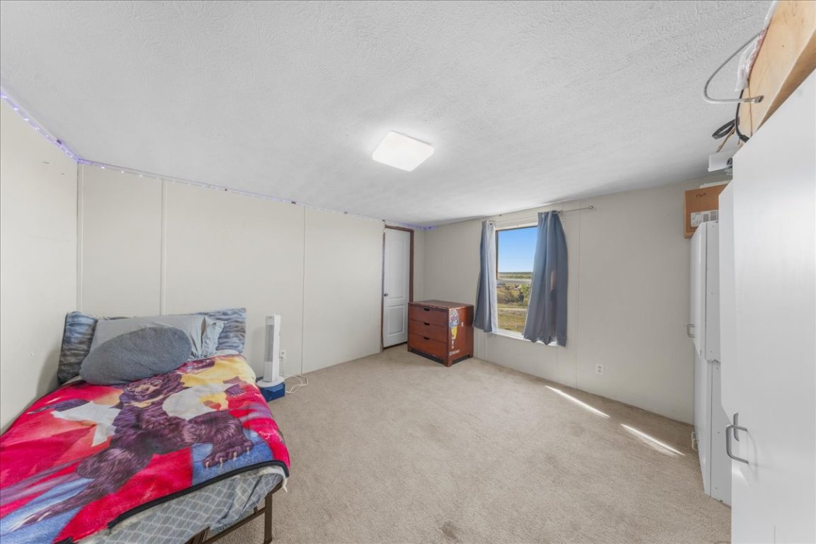 1307 Graef Road, Unit B Kyle, TX 78640 - Photo 31 of 40 a bedroom with a bed and a cabinets