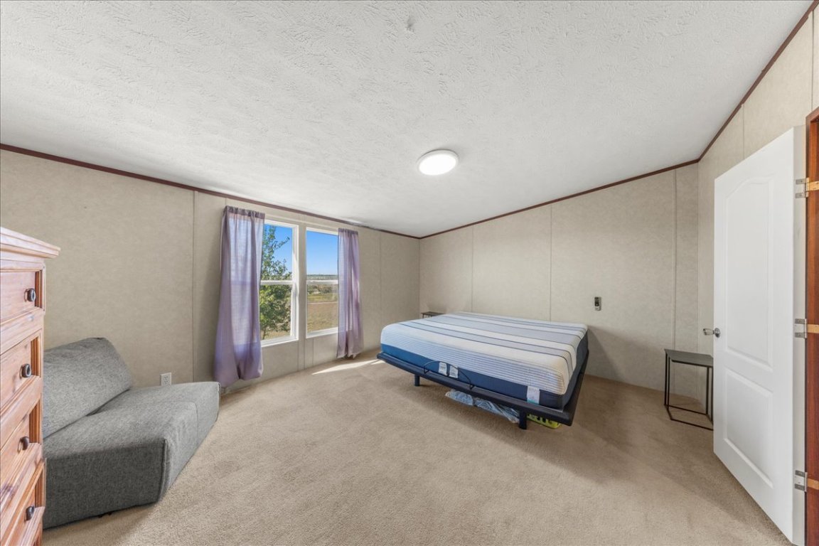 1307 Graef Road, Unit B Kyle, TX 78640 - Photo 35 of 40 a bedroom with a bed and a window