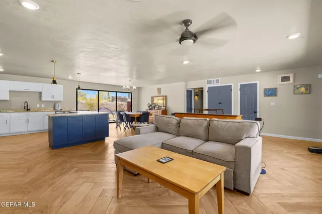 a living room with furniture and kitchen view