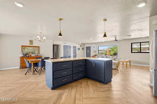 a living room with furniture and a dining table with kitchen view