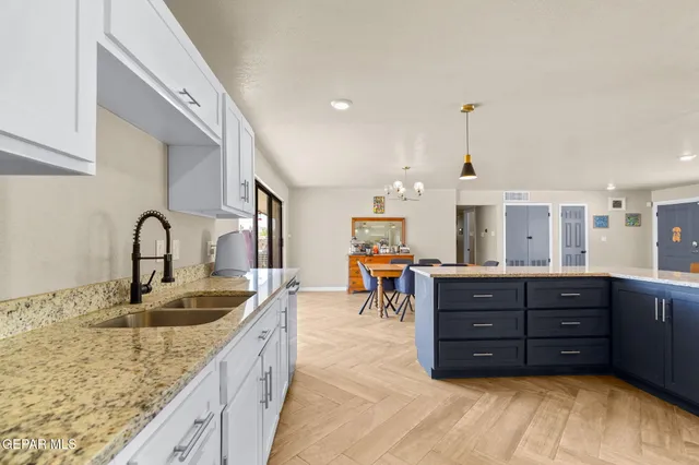 a kitchen with granite countertop a sink and cabinets