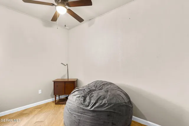 a bedroom with a bed and a ceiling fan