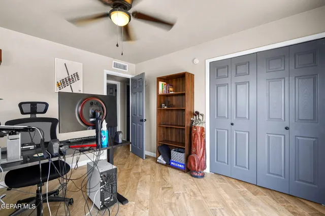 a view of a workspace with furniture and a window