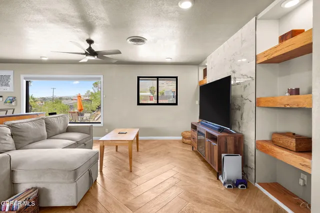 a living room with furniture and a flat screen tv