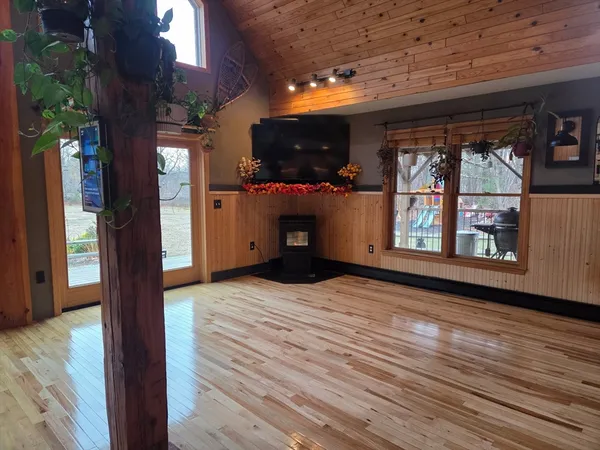 a view of an empty room with a fireplace and a window