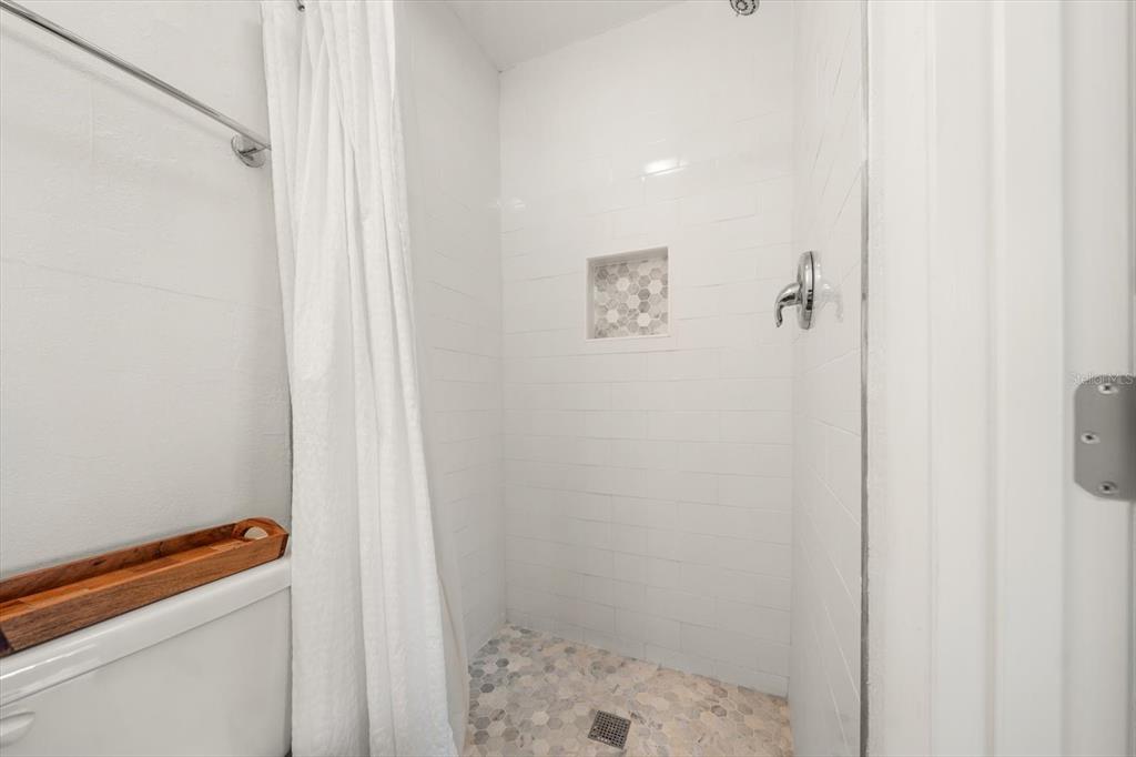 127 11th Avenue Indian Rocks Beach, FL 33785 - Photo 21 of 63 a bathroom with a shower