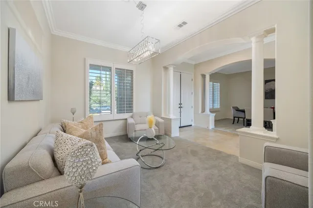 a living room with furniture and floor to ceiling window