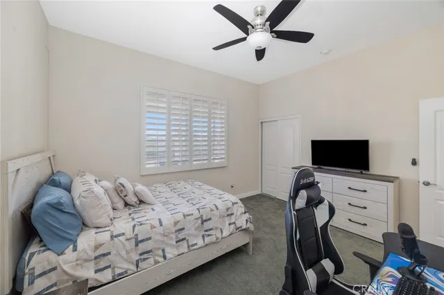 a bedroom with a bed and a television