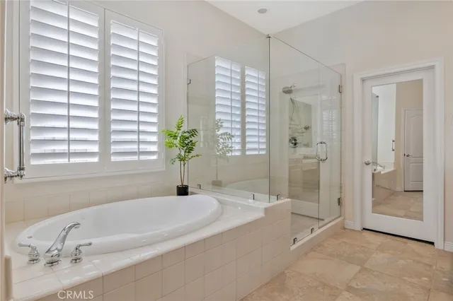 a spacious bathroom with a bathtub and shower