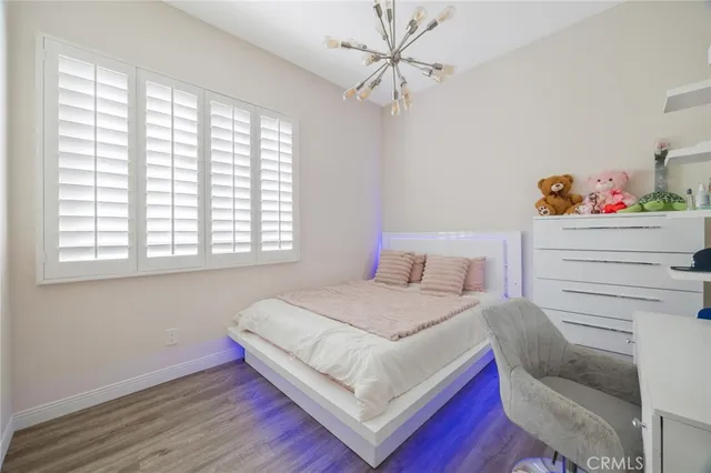 a bedroom with a bed and a chandelier