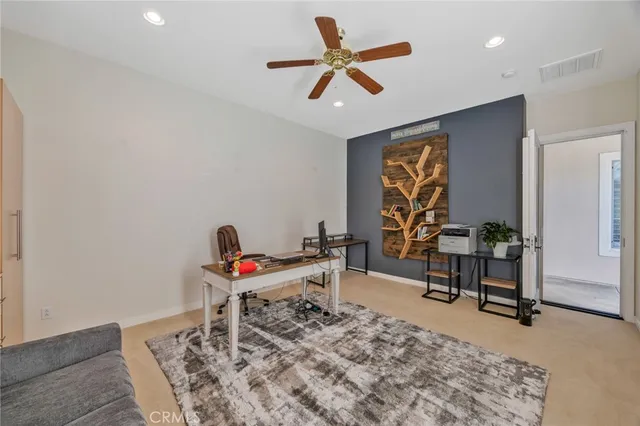 a living room with furniture a rug and a window