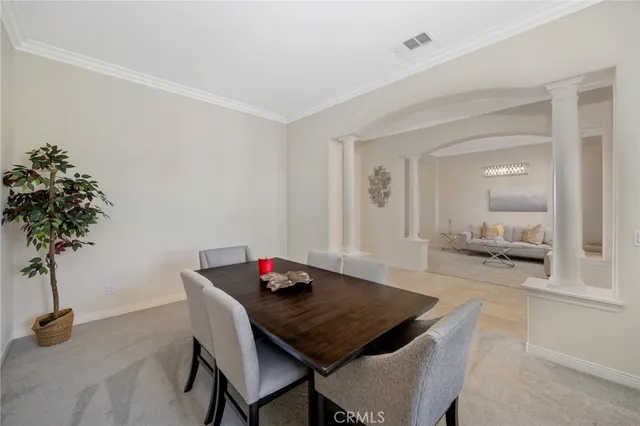 a view of a room that has a table and chairs in it