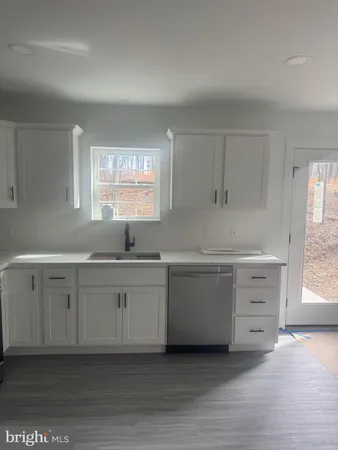 a kitchen with sink cabinets and window