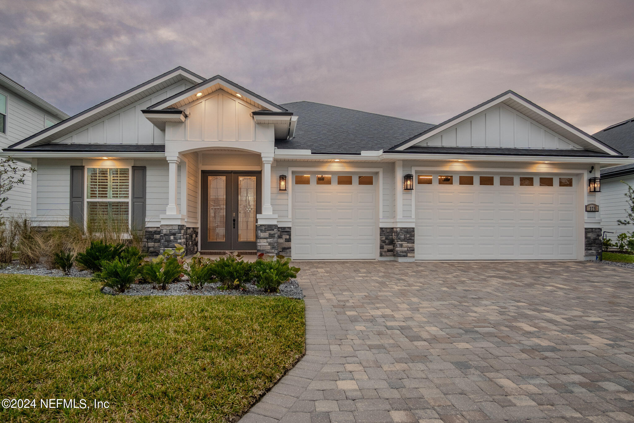 a front view of a house with garden