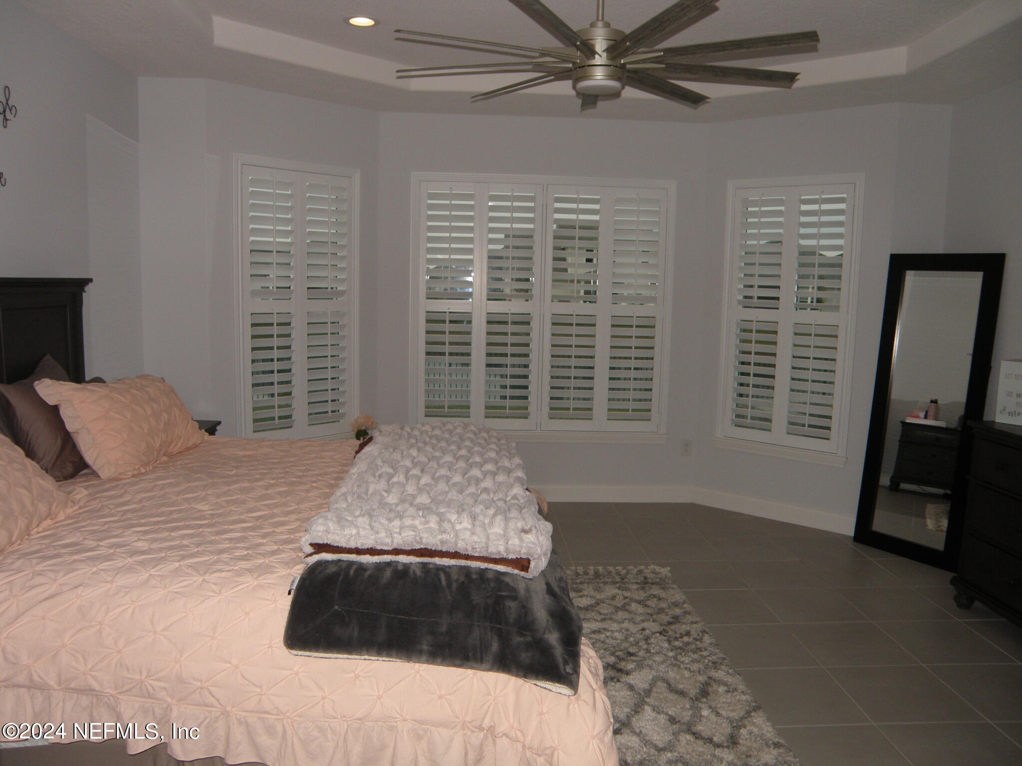 375 Silver Pine Drive St. Augustine, FL 32092 - Photo 26 of 84 a bedroom with a bed a dresser and a window