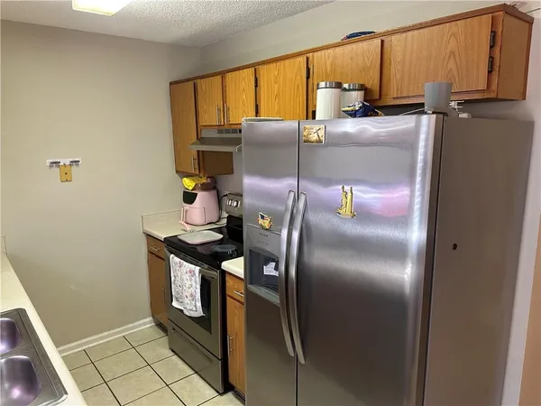 a kitchen with a refrigerator and a sink