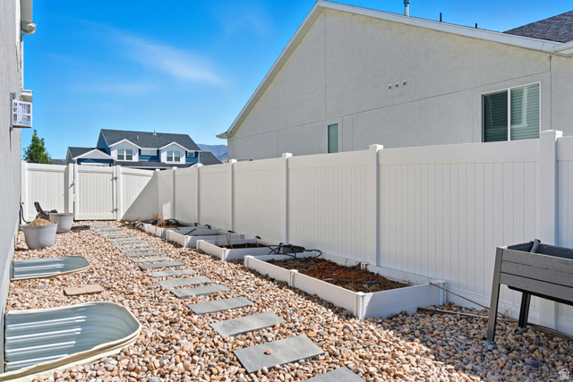 572 South Chamberlain Street Mapleton, UT 84664 - Photo 41 of 56 Fenced backyard featuring a gate and a garden