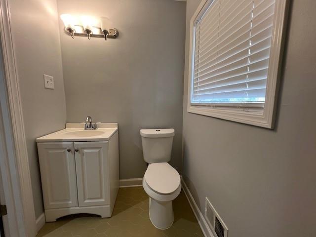 6935 Fielder Road Rex, GA 30273 - Photo 10 of 22 a bathroom with a toilet sink and mirror