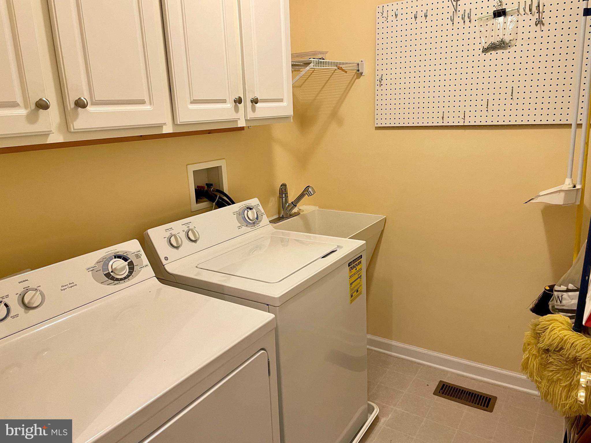 8258 Academy Road, Unit 6 Ellicott City, MD 21043 - Photo 33 of 36 Main-level utility room w/built-in cabinetry